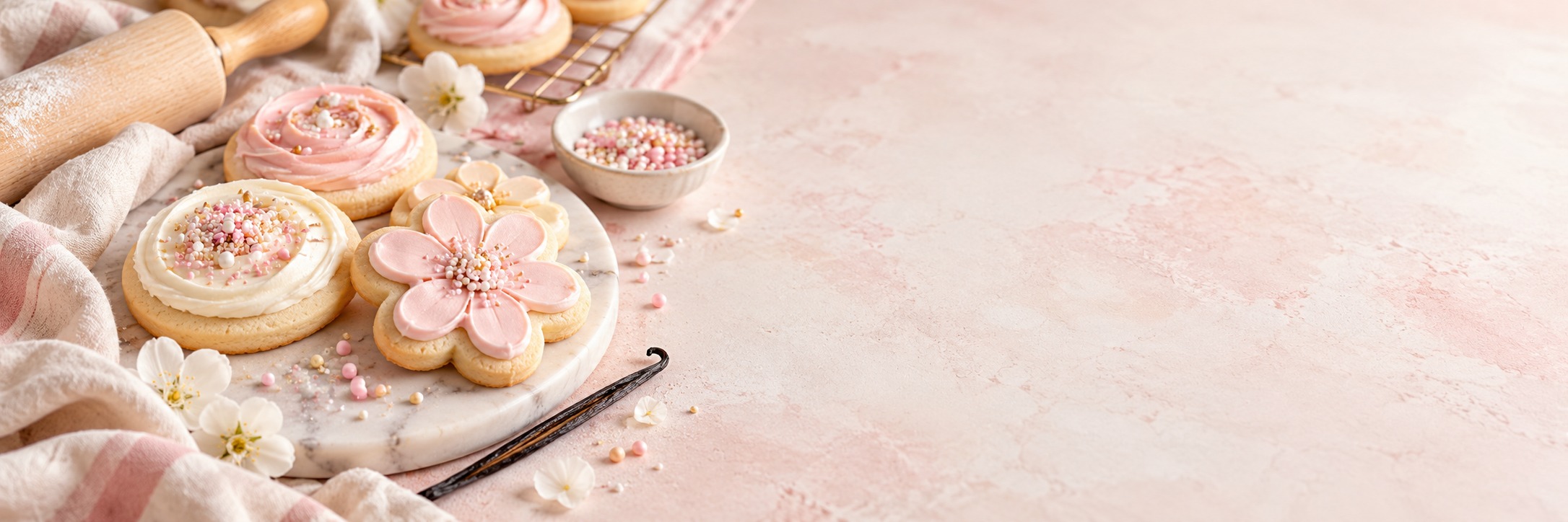 Pastel frosted sugar cookies in a bright baking kitchen
